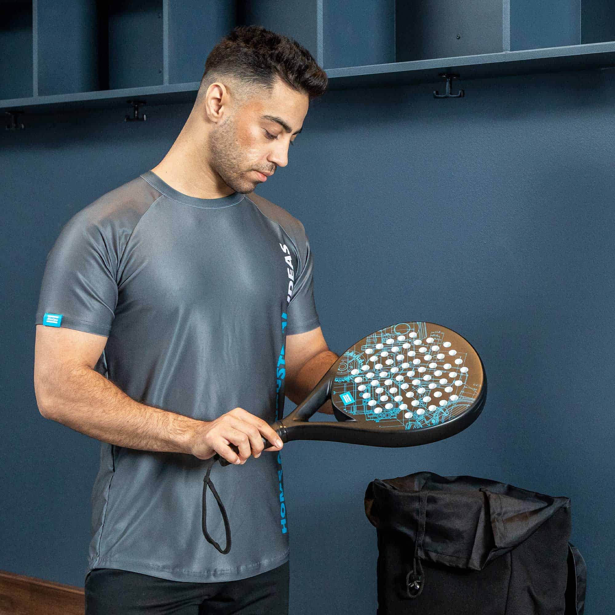 black padel racket with blueprint pattern and active tee